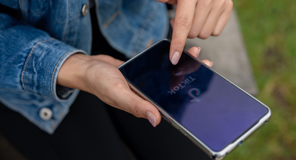 A person hold a mobile phone with TikTok loaded